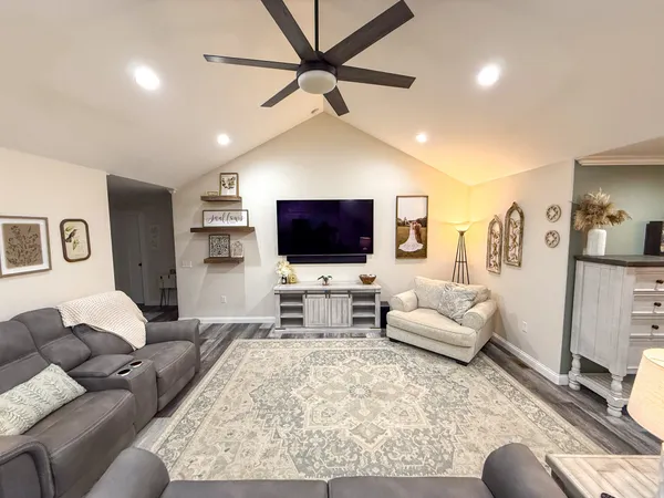 a living room with furniture and a flat screen tv
