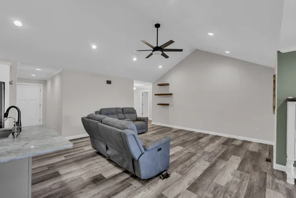 a living room with couch and a wooden floor