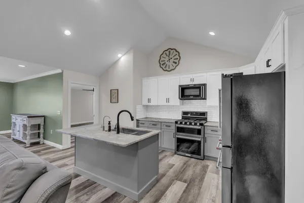 a kitchen with a refrigerator and a sink
