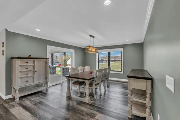 a dining room with furniture and wooden floor