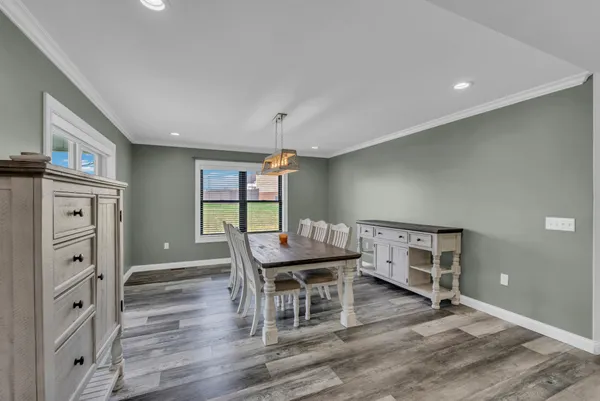 a dining room with furniture and wooden floor