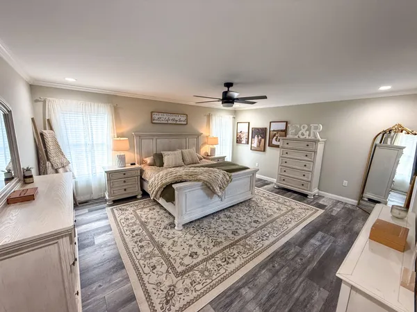 a living room with furniture a flat screen tv and a rug