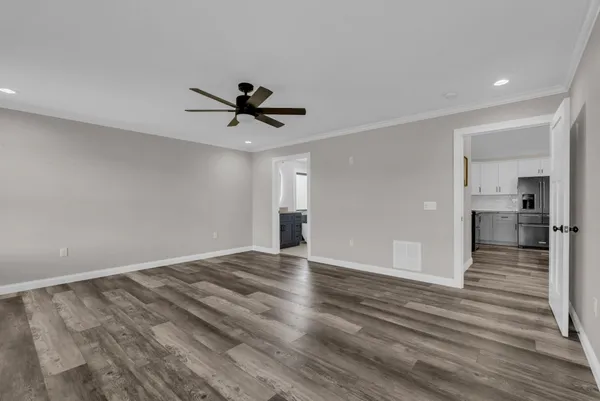 a view of empty room with wooden floor