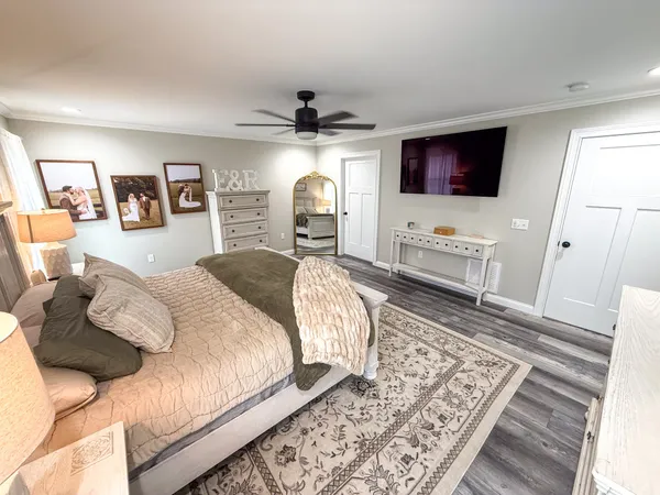 a bedroom with a large bed and a flat screen tv