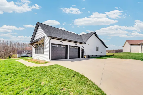 a view of a house with a backyard porch and sitting area
