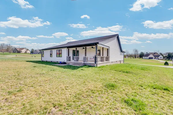 a backyard of a house with table and chairs