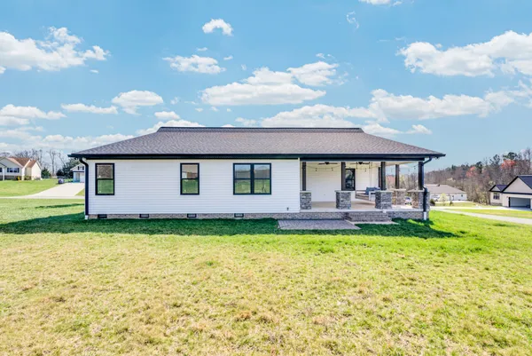 a view of a livingroom with a ceiling fan and window
