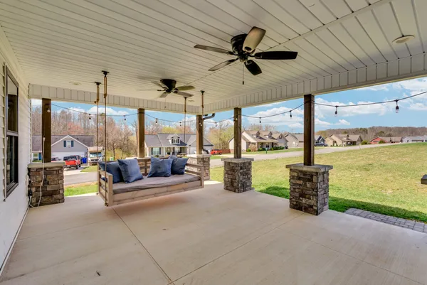 a living room with patio furniture and a fireplace