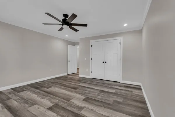 a view of empty room with ceiling fan
