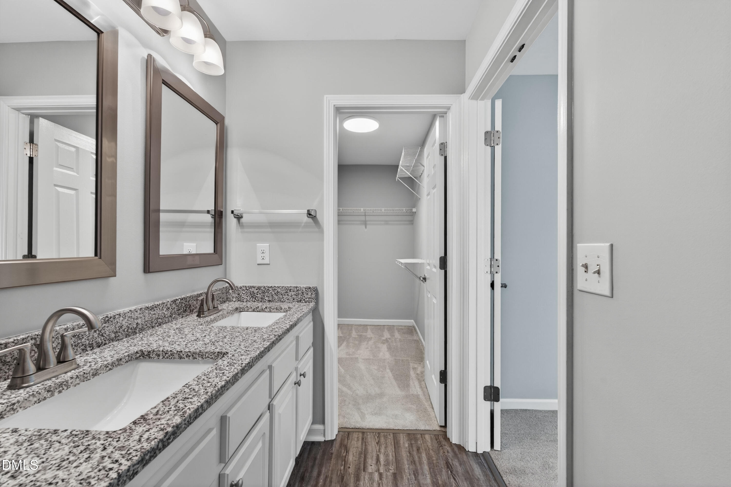 5421 Golden Arrow Lane Raleigh, NC 27613 - Photo 32 of 49 a bathroom with a granite countertop double vanity sink and mirror