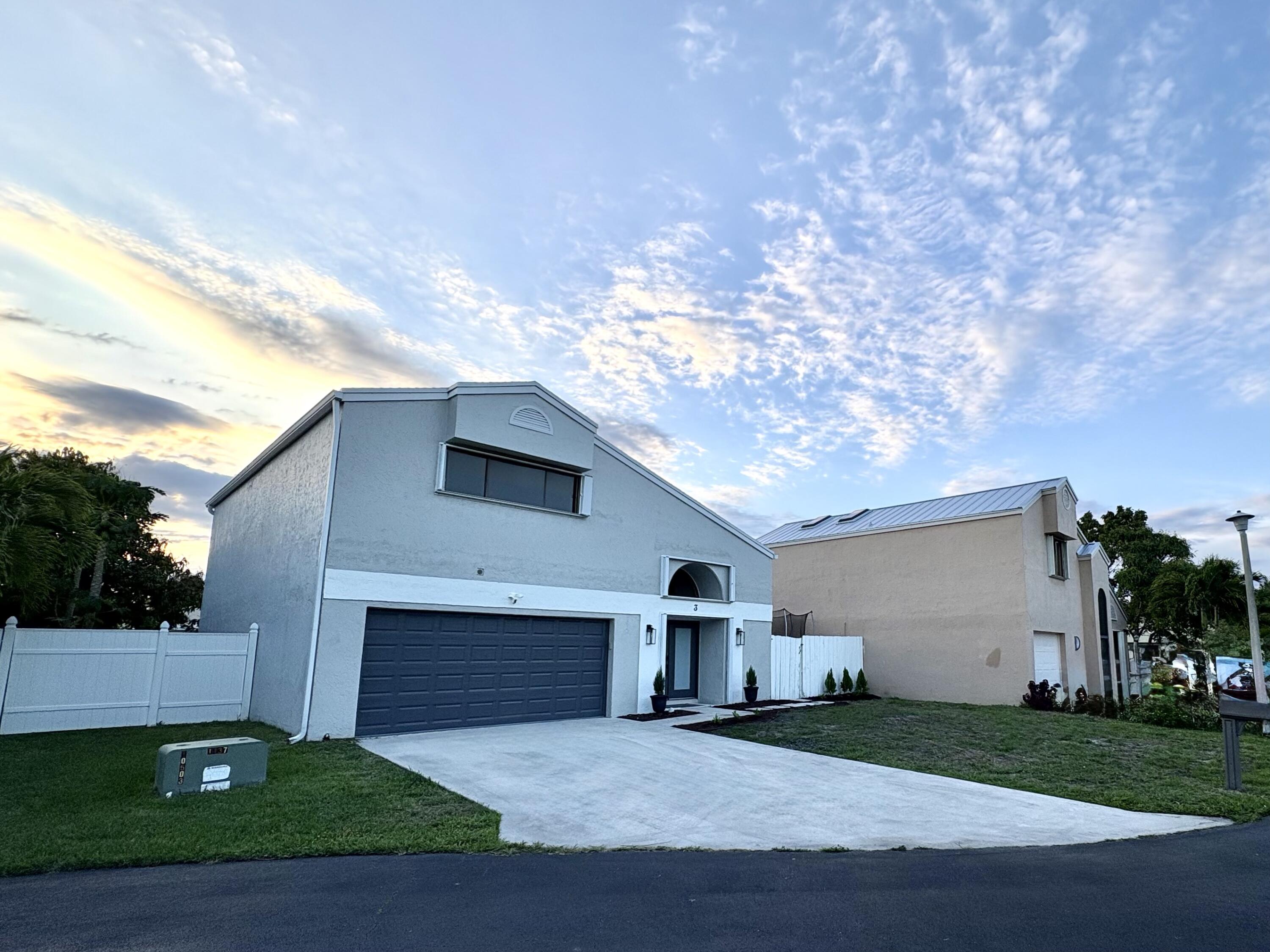 3 Kyle Way Boynton Beach, FL 33426 - Photo 1 of 36 a front view of a house with a yard and garage