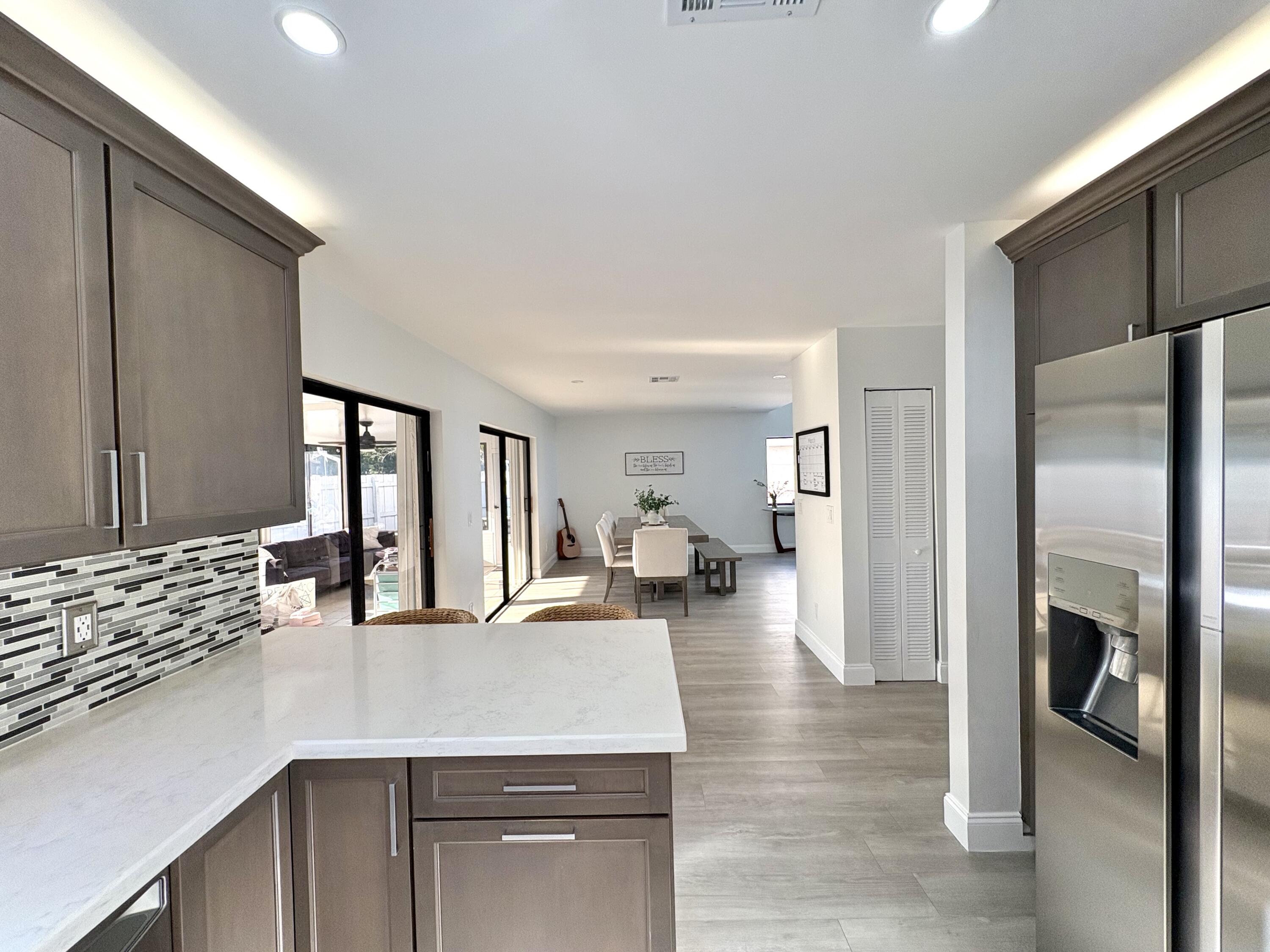 3 Kyle Way Boynton Beach, FL 33426 - Photo 12 of 36 a kitchen with stainless steel appliances granite countertop a refrigerator and a sink