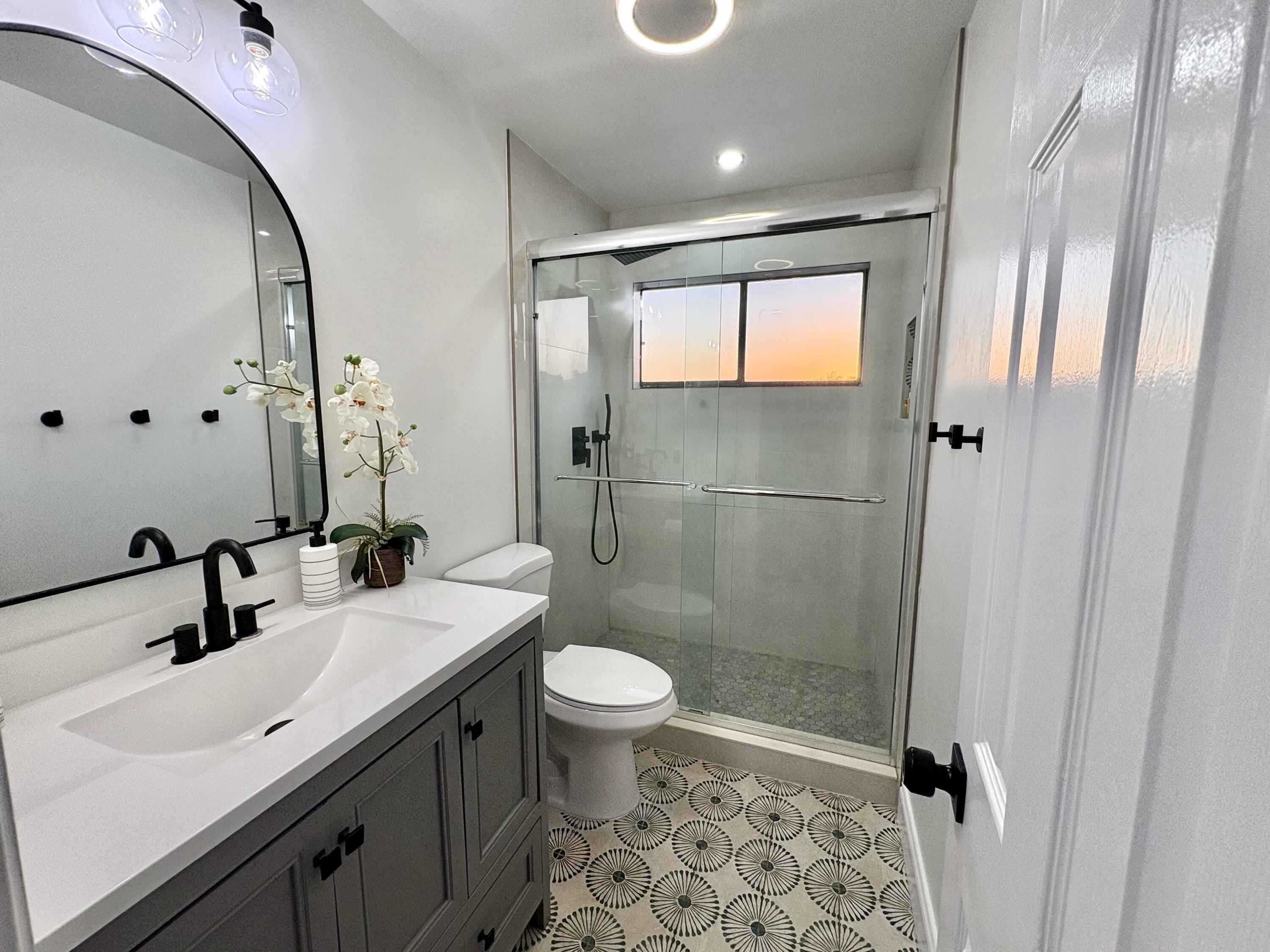 3 Kyle Way Boynton Beach, FL 33426 - Photo 14 of 36 a bathroom with a sink a toilet and shower