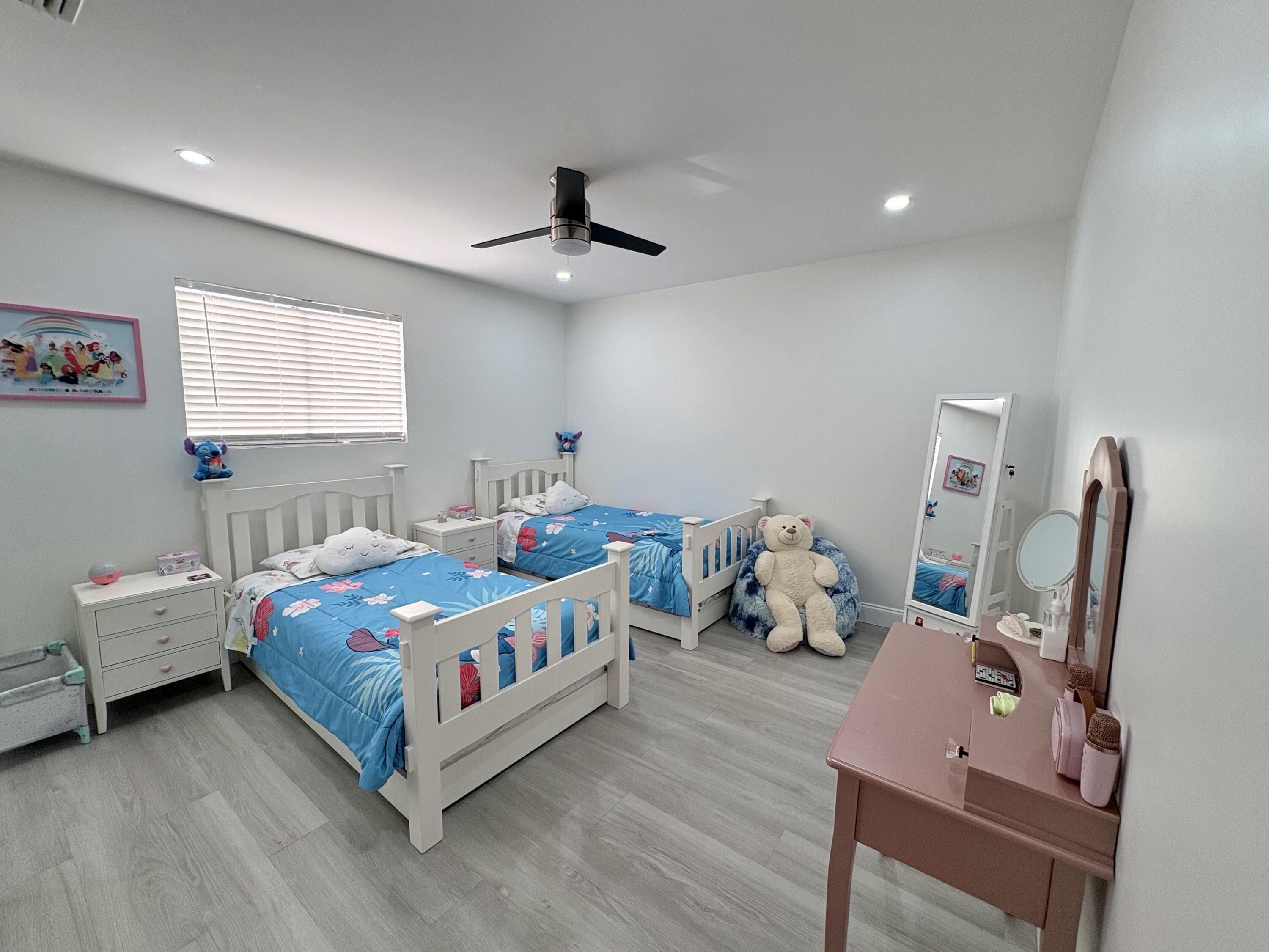 3 Kyle Way Boynton Beach, FL 33426 - Photo 17 of 36 a room with a bed and wooden floor