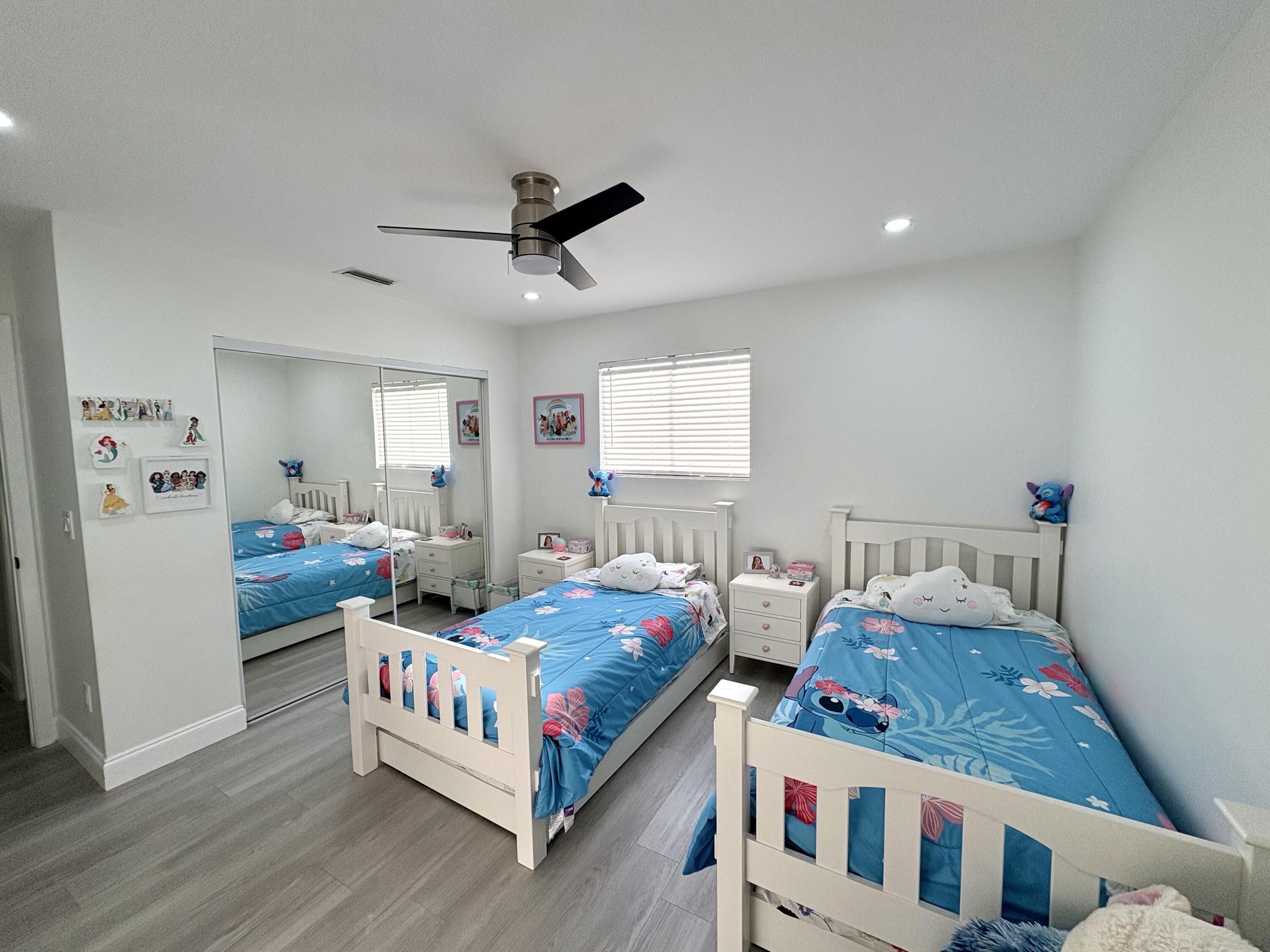 3 Kyle Way Boynton Beach, FL 33426 - Photo 18 of 36 a bedroom with two beds and white walls