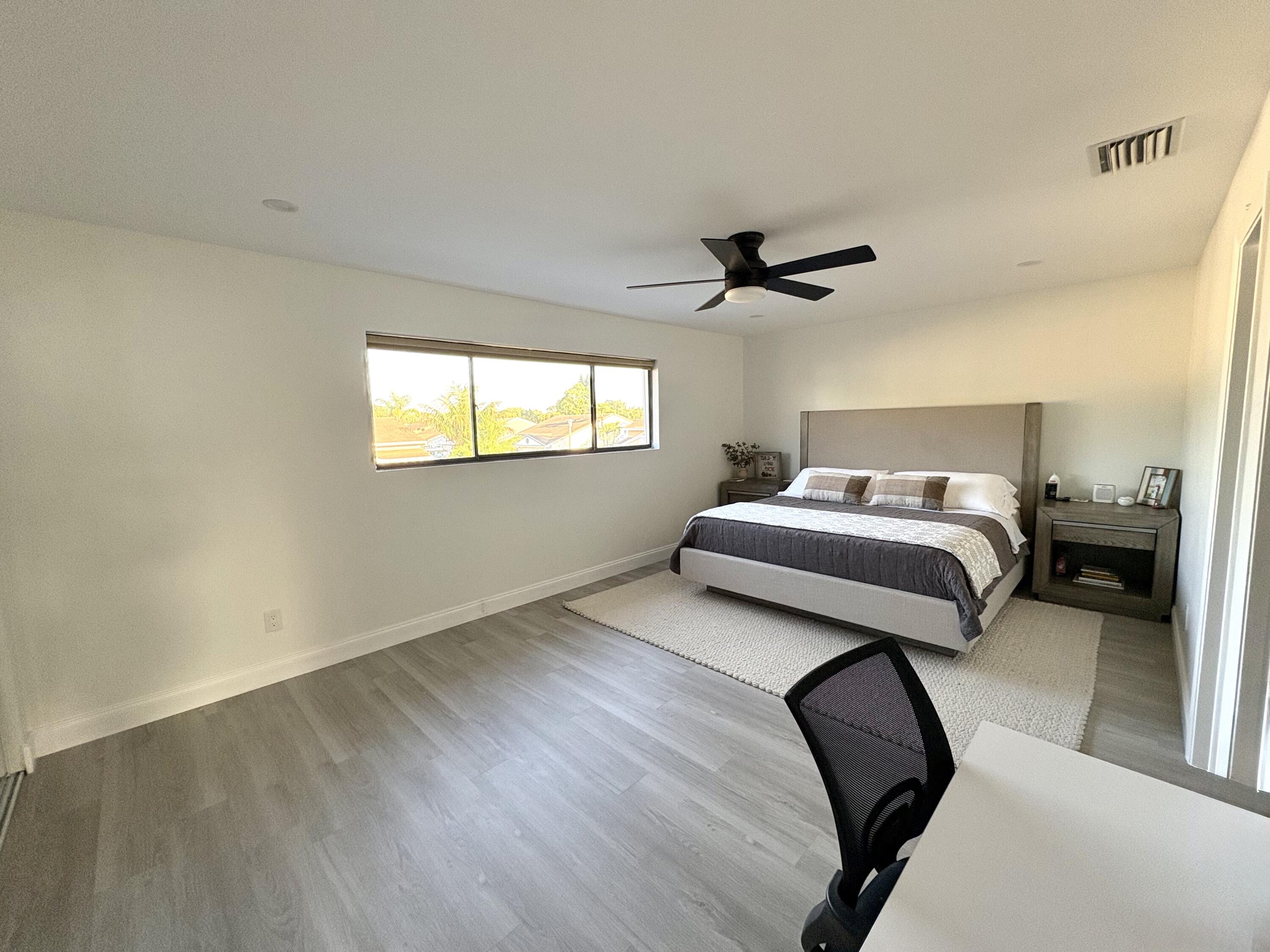3 Kyle Way Boynton Beach, FL 33426 - Photo 19 of 36 a bedroom with a bed and a ceiling fan