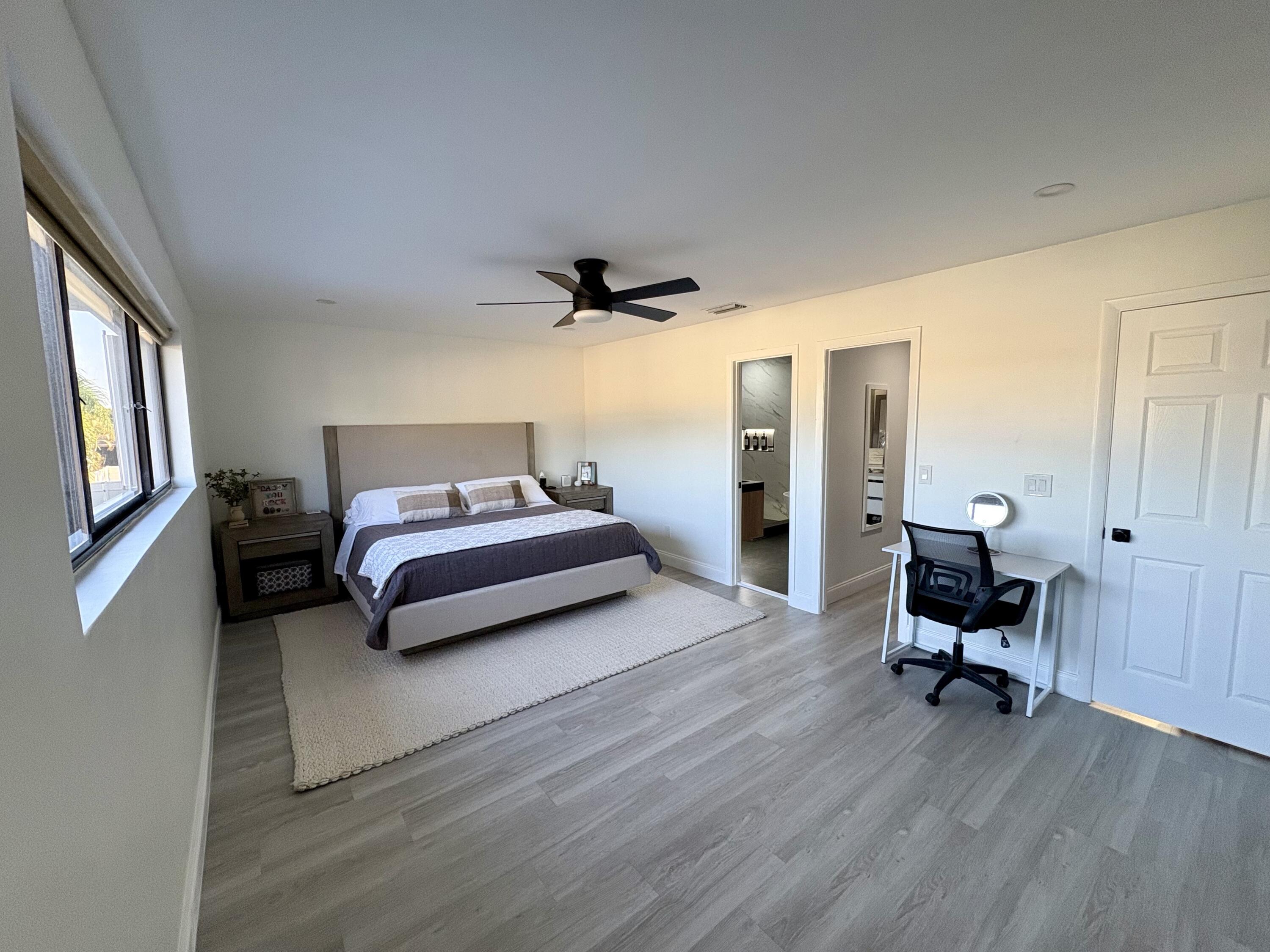 3 Kyle Way Boynton Beach, FL 33426 - Photo 20 of 36 a bedroom with a bed and wooden floor
