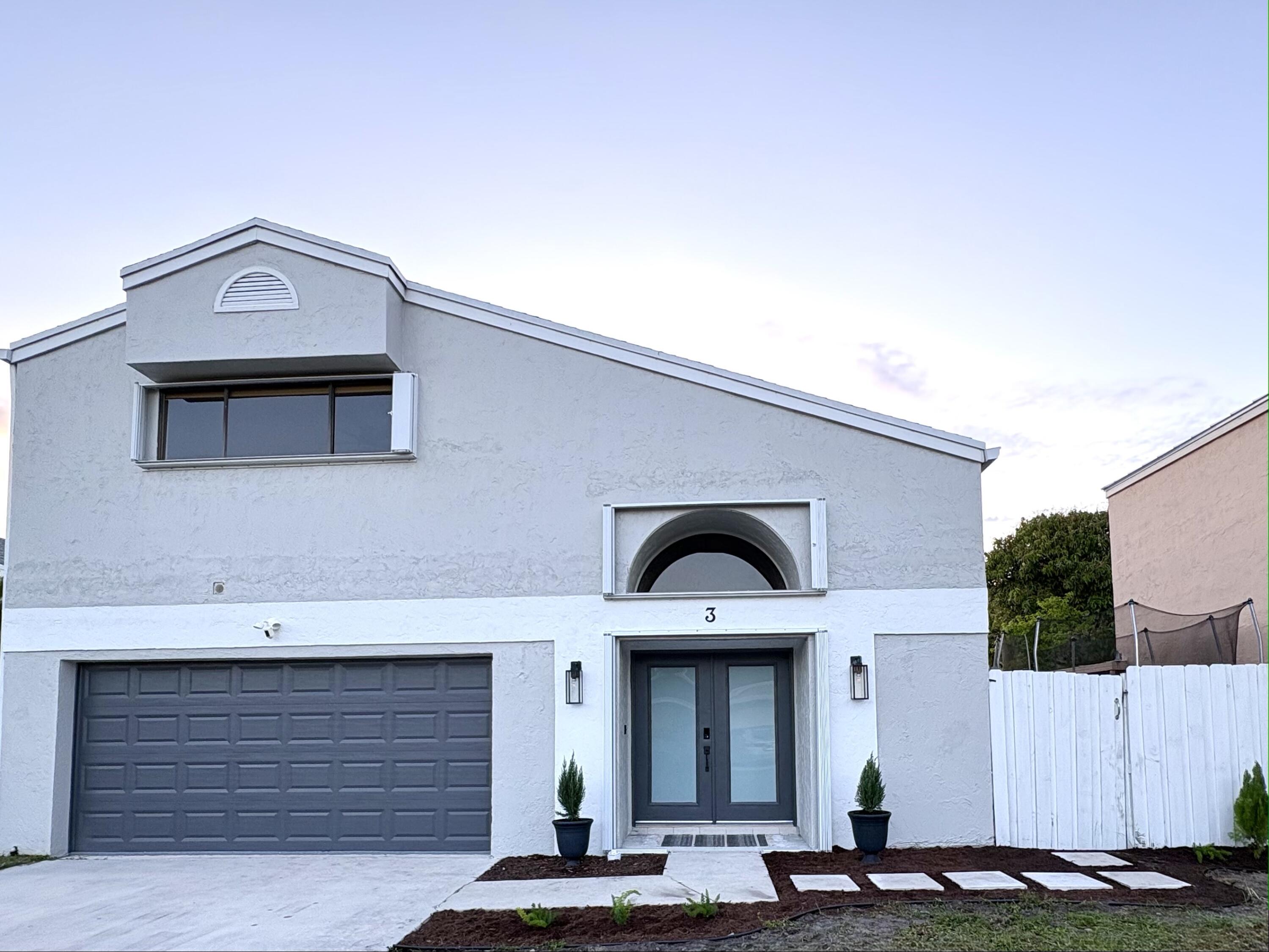 3 Kyle Way Boynton Beach, FL 33426 - Photo 2 of 36 a front view of a house with garage