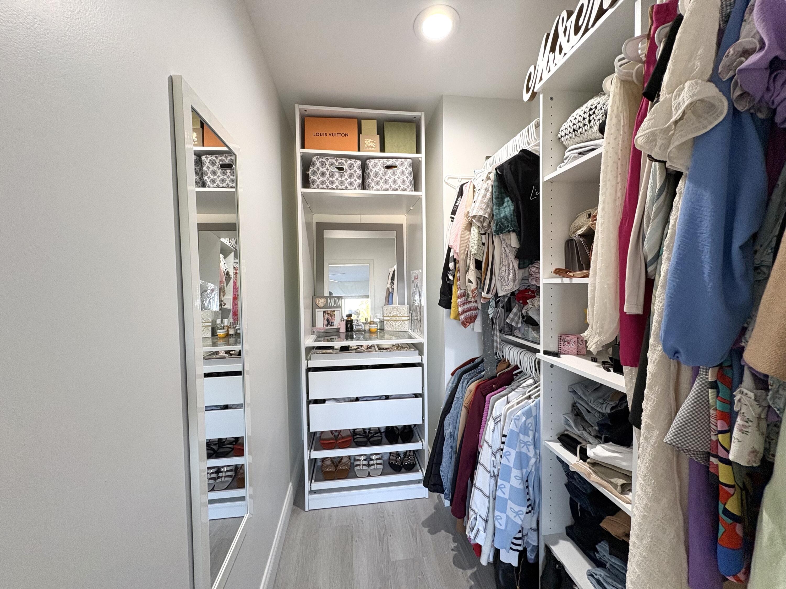 3 Kyle Way Boynton Beach, FL 33426 - Photo 23 of 36 a view of walk in closet with clothes and shoes