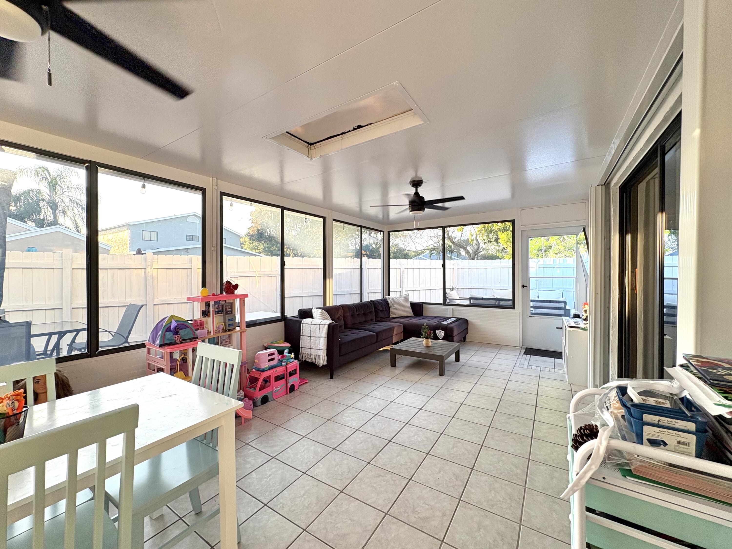 3 Kyle Way Boynton Beach, FL 33426 - Photo 26 of 36 a living room with furniture and large windows