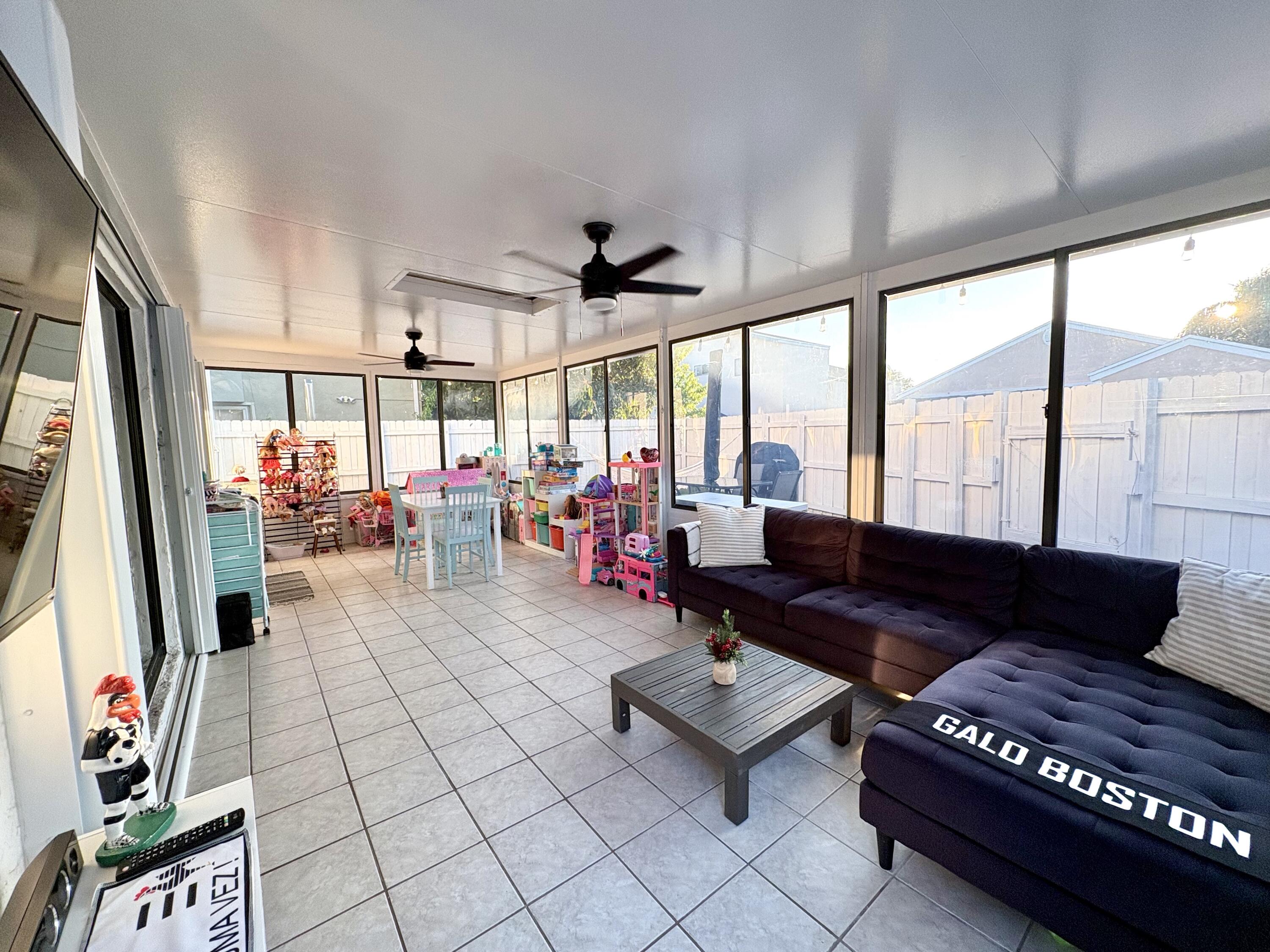 3 Kyle Way Boynton Beach, FL 33426 - Photo 27 of 36 a living room with furniture and a flat screen tv