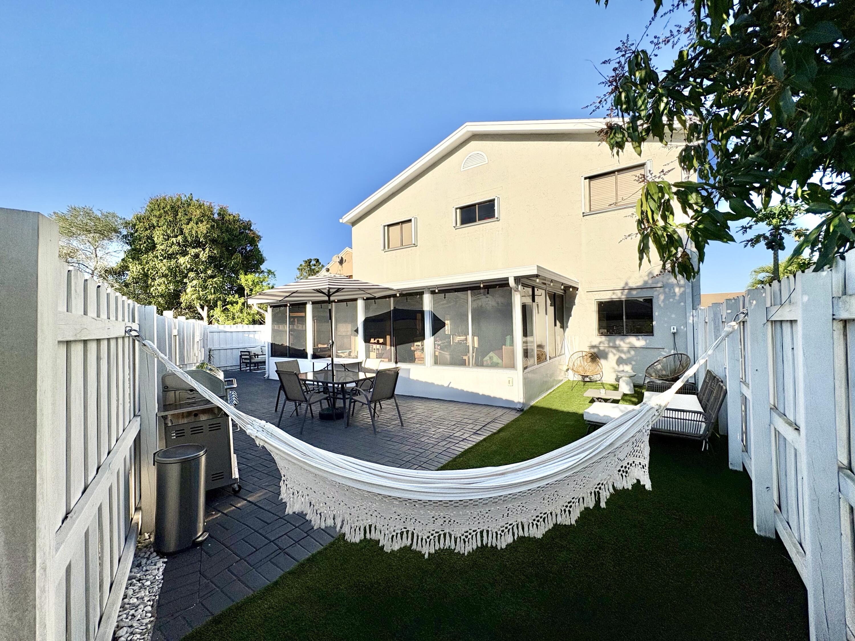 3 Kyle Way Boynton Beach, FL 33426 - Photo 29 of 36 a front view of house with outdoor seating