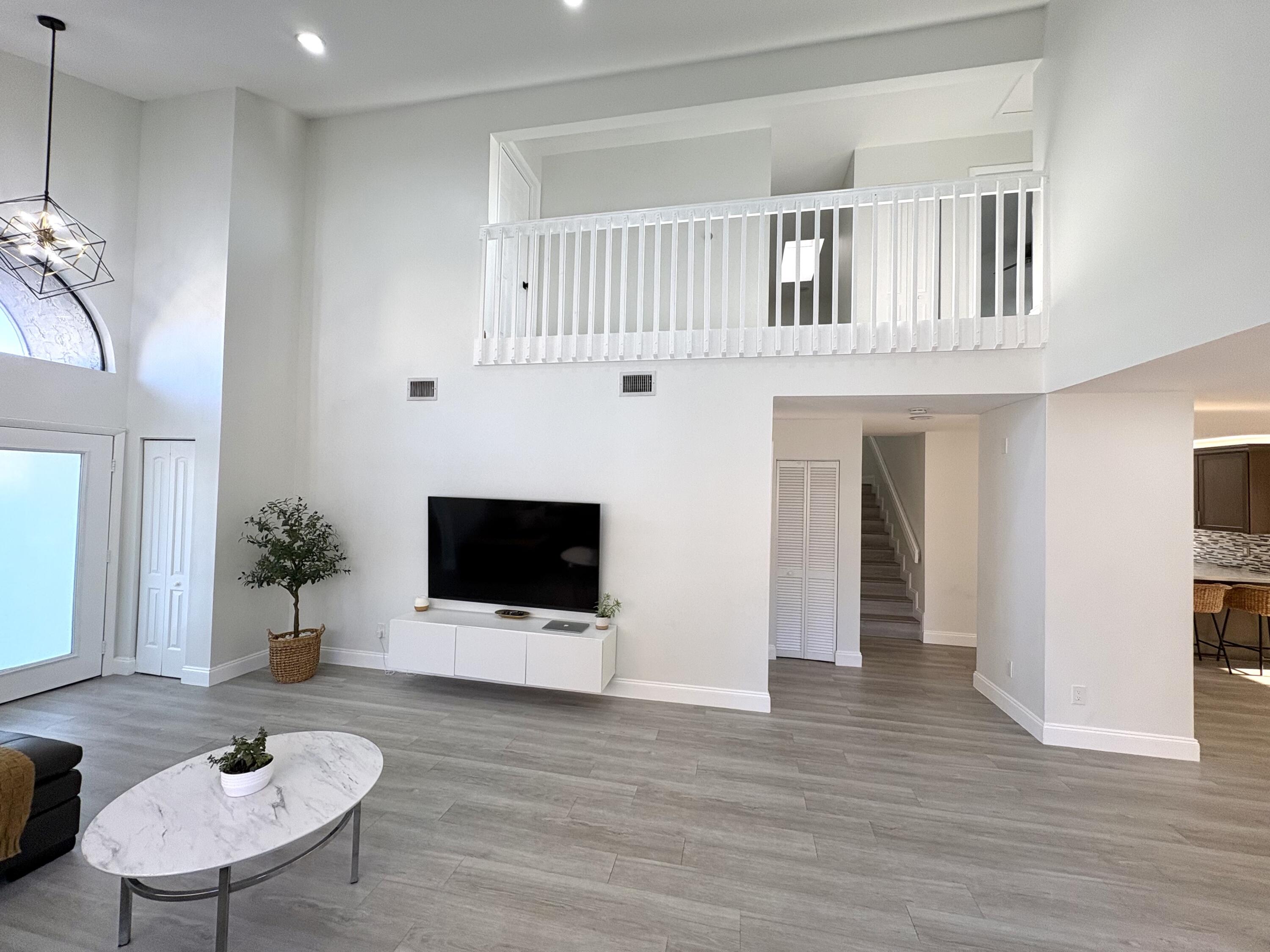 3 Kyle Way Boynton Beach, FL 33426 - Photo 5 of 36 a living room with furniture and a flat screen tv