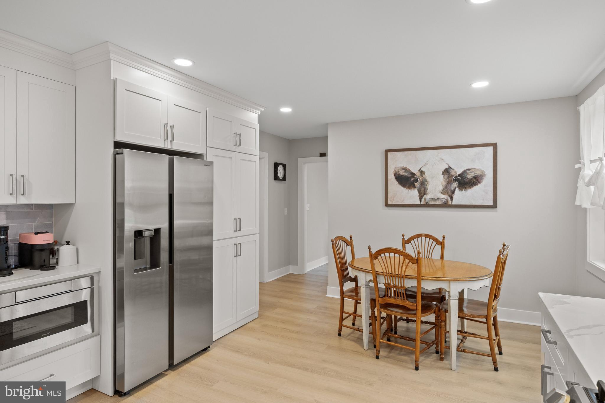218 Pleasant Mills Road Hammonton, NJ 08037 - Photo 14 of 36 a kitchen with stainless steel appliances refrigerator dining table and chairs