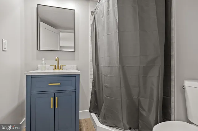 a bathroom with a toilet sink shower and mirror