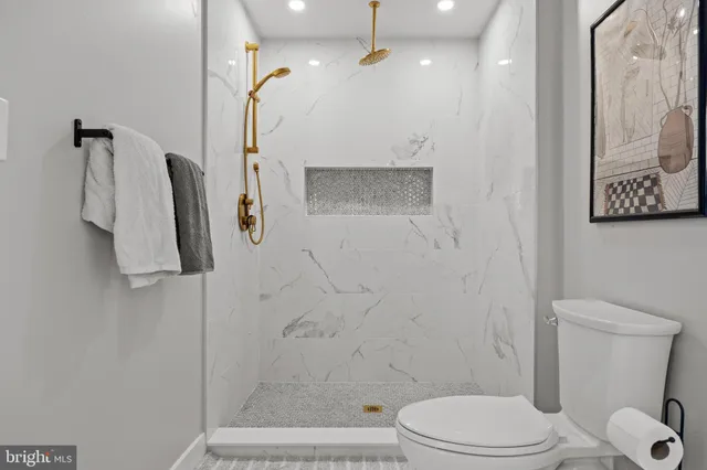 a bathroom with a toilet sink and shower