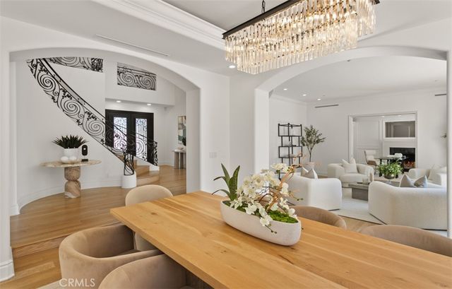 a dining room with furniture window and wooden floor