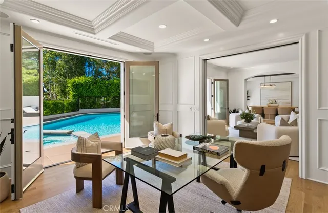 a living room with furniture fireplace and a floor to ceiling window