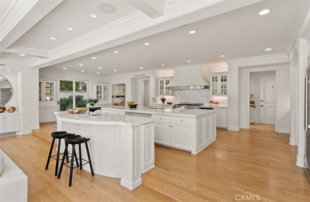 a view of a patio with couches table and chairs under an umbrella with a fire pit