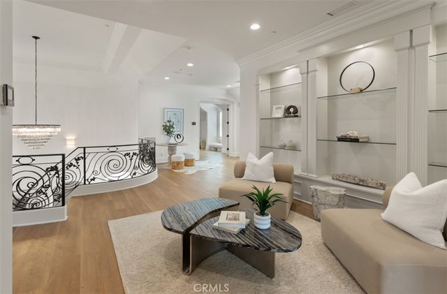 a bedroom with a bed lamps and wooden floor