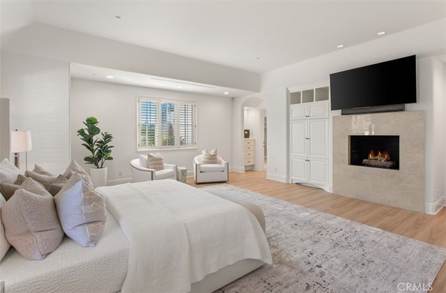 a spacious bedroom with a large bed and a flat screen tv