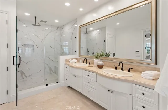 a bathroom with a shower sink and mirror