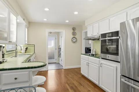 a kitchen with stainless steel appliances a sink stove and refrigerator