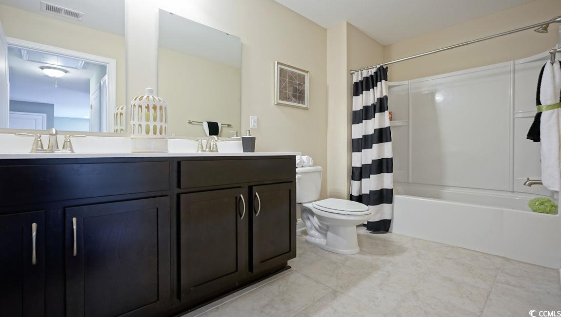 708 Rupert Drive Conway, SC 29526 - Photo 33 of 35 Bathroom with double vanity, shower / bath combination with curtain, toilet, and tile patterned floors