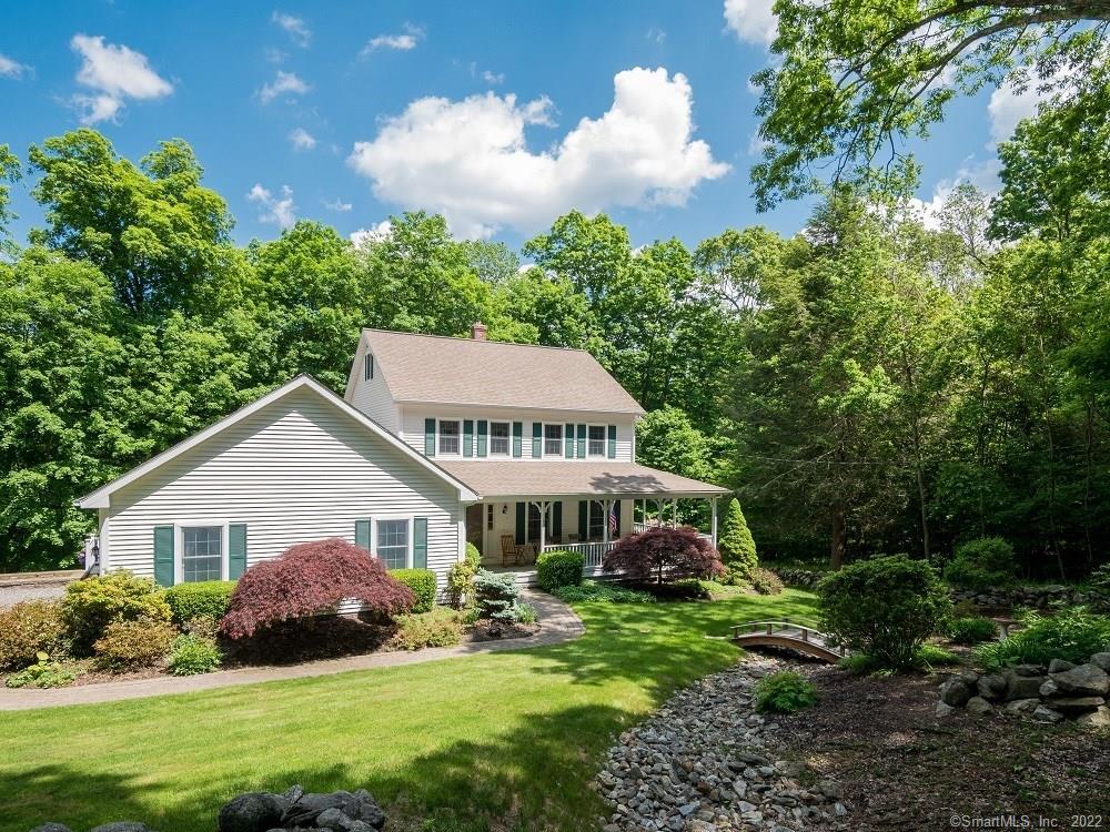 202 North Bedlam Road Chaplin, CT 06235 - Photo 1 of 1 a front view of a house with a garden and trees