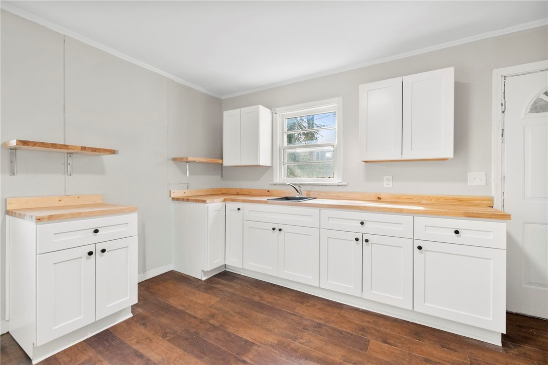 825 Dora Drive Anderson, SC 29624 - Photo 11 of 27 This newly renovated kitchen features sleek white cabinetry and warm wood countertops.