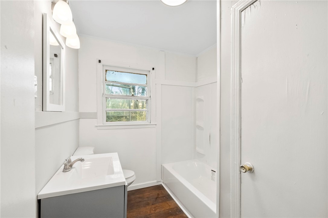 825 Dora Drive Anderson, SC 29624 - Photo 16 of 27 This bathroom features a sleek vanity, a bathtub, and a window for natural light.