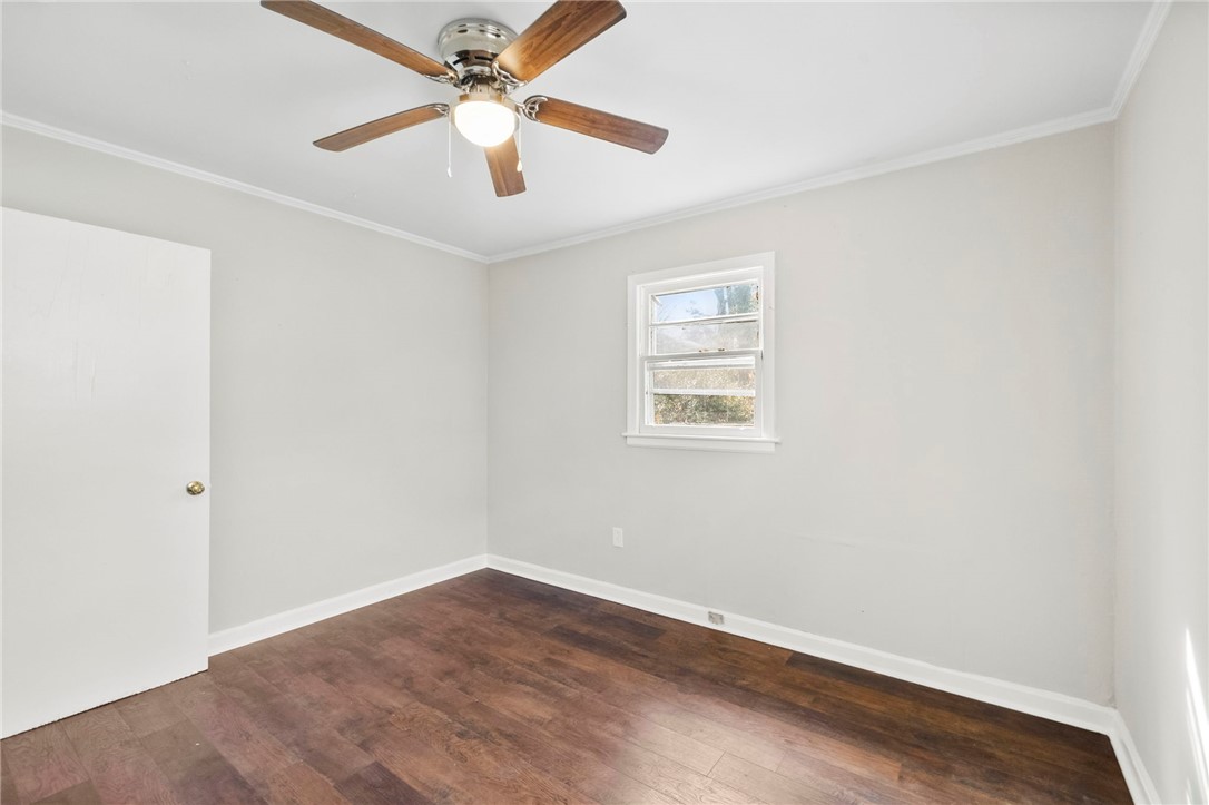 825 Dora Drive Anderson, SC 29624 - Photo 22 of 27 This bright room features a window overlooking lush greenery and rich wood flooring.