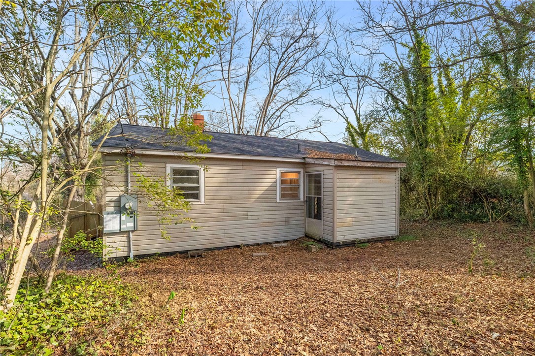 825 Dora Drive Anderson, SC 29624 - Photo 25 of 27 This charming home features classic vinyl siding and a durable shingle roof, surrounded by natural landscaping.