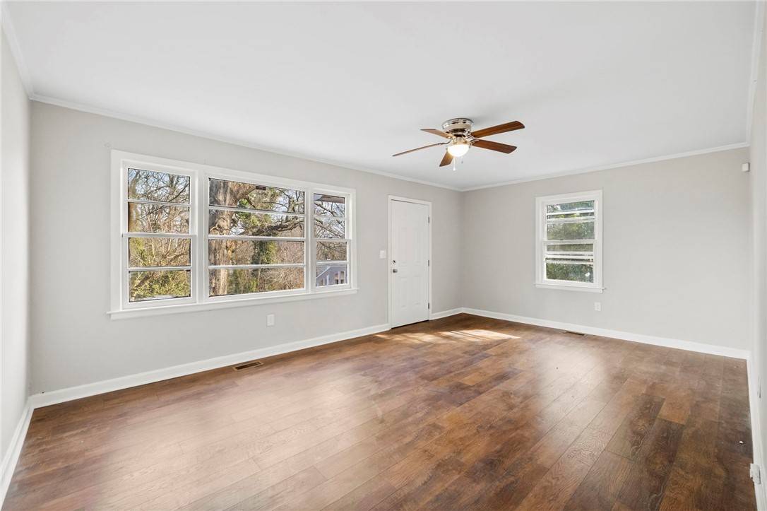 825 Dora Drive Anderson, SC 29624 - Photo 6 of 27 This bright living space features abundant natural light and rich wood flooring.