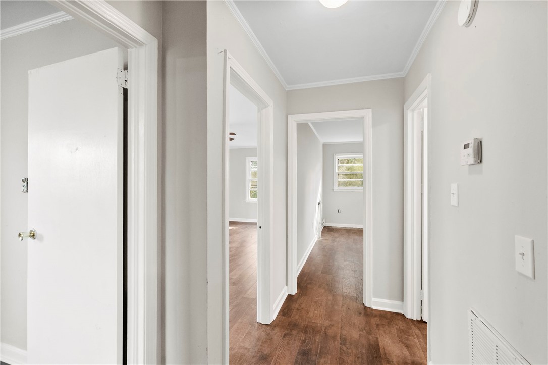 825 Dora Drive Anderson, SC 29624 - Photo 8 of 27 This spacious hallway features rich hardwood flooring and leads to sunlit rooms.