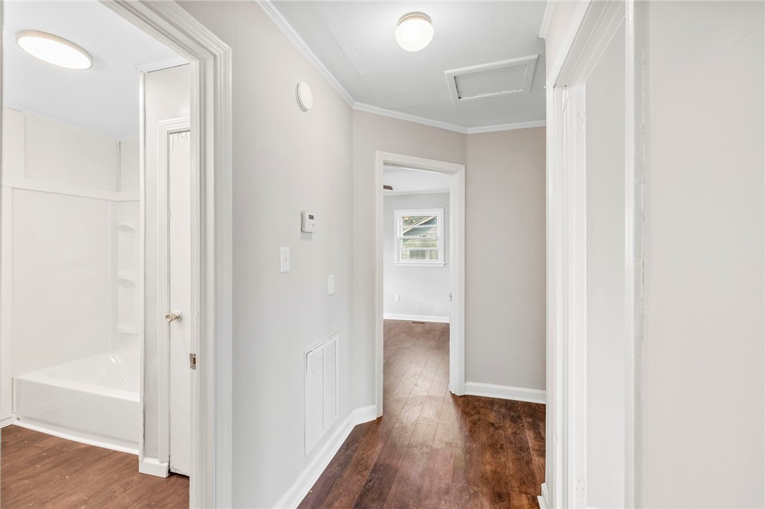 825 Dora Drive Anderson, SC 29624 - Photo 9 of 27 This home features rich wood flooring and crown molding, enhancing its architectural appeal.