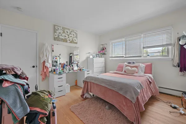 a bedroom with a bed and a window