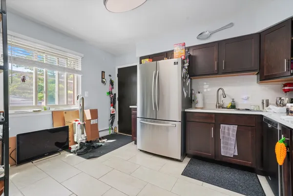 a kitchen with a refrigerator a stove and a sink