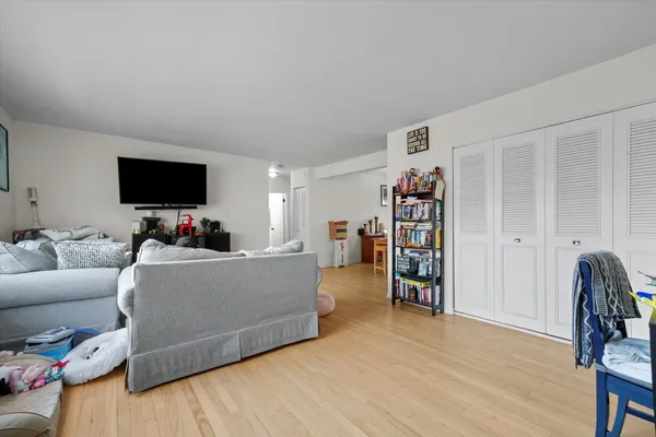 a view of a a dining room with furniture window and wooden floor