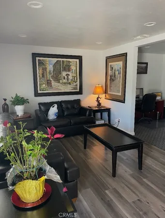a living room with furniture and a potted plant